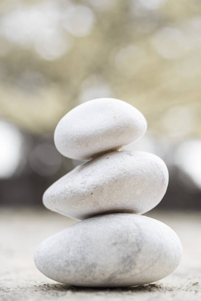 A pile of three white stones isolated on blurred background - Photo, Image