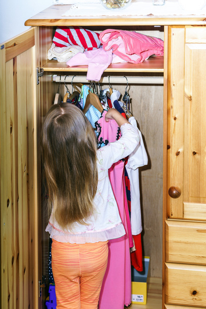 Cute little girl hanging up her clothes - Φωτογραφία, εικόνα