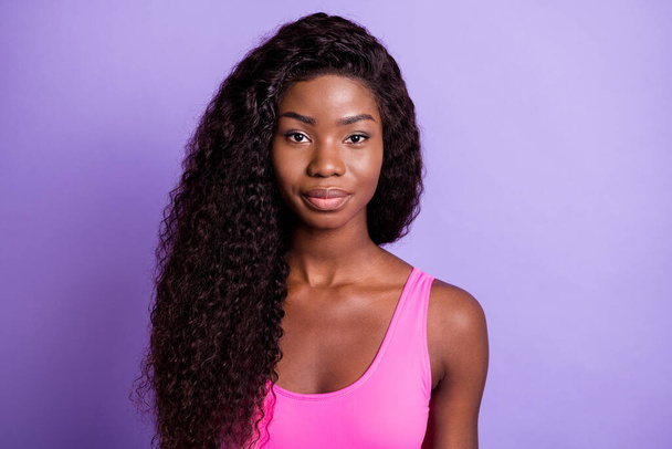 Photo of young attractive african wavy hair woman serious confident isolated over violet color background - 写真・画像