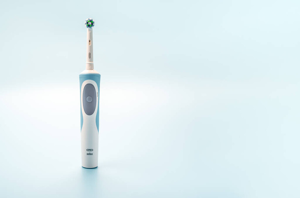 Russia, Moscow, july 22, 2021: Braun Oral-B toothbrush head Cross Action. modern electric toothbrush on light blue background. horizontal. copy space - Фото, изображение