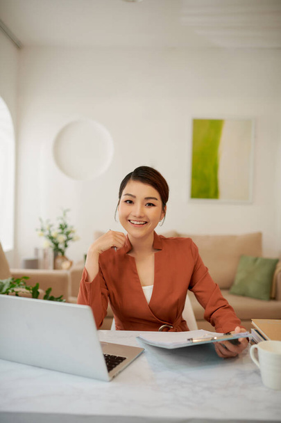 Adorable attractive smart clever young smiling woman working sitting in office at work place work station - Photo, Image