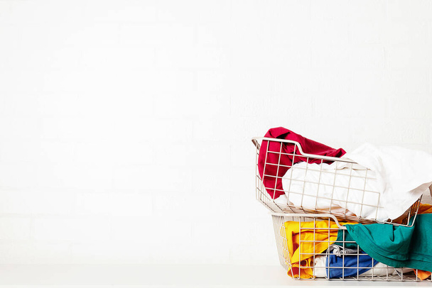 Pile of dirty, colorful laundry in baskets.  - Photo, image