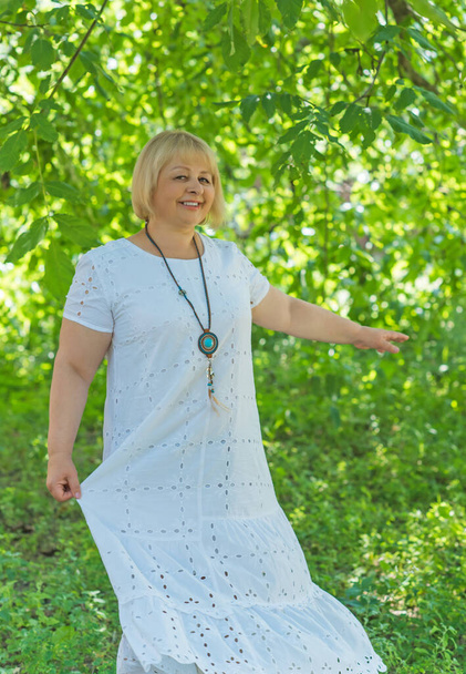Portrait of attractive plus size mature woman in casual style walk at good sunny day. Life of women after 40-50 years - Photo, Image