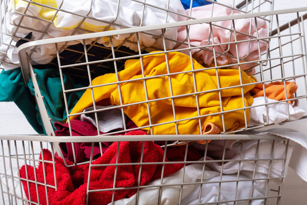 Pile of dirty, colorful laundry in baskets.  - Photo, image