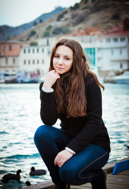 portrait of young charming brunette girl on the waterfront - Foto, Imagem