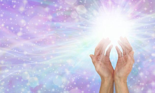 Healing Hands Message Banner - vrouwelijke handen aan de rechterkant reikend in wit licht boven tegen een sprankelende paarse roze blauwe bokeh achtergrond met veel kopieerruimte - Foto, afbeelding