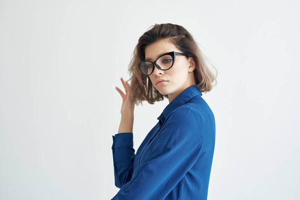 woman in blue shirt wearing glasses elegant style self-confidence studio - Valokuva, kuva