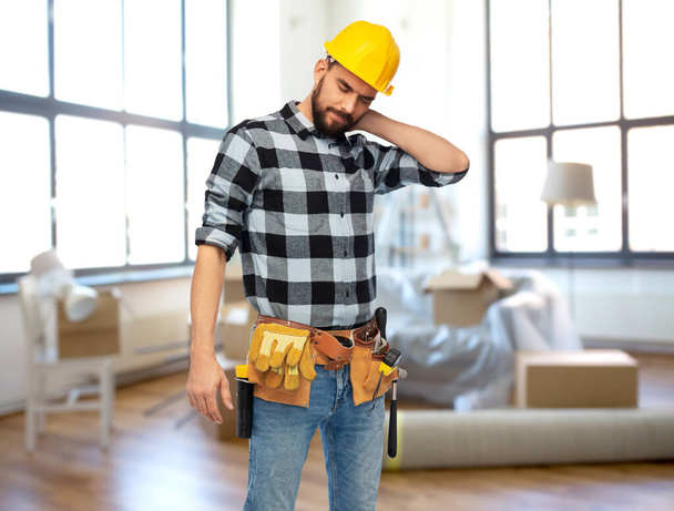 male worker or builder with neck pain at home - Fotoğraf, Görsel