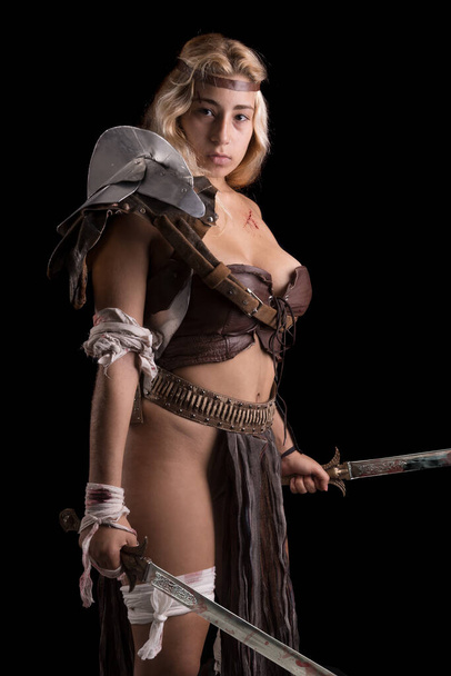 Ancient woman warrior or Gladiator posing in a dark background - Photo, Image
