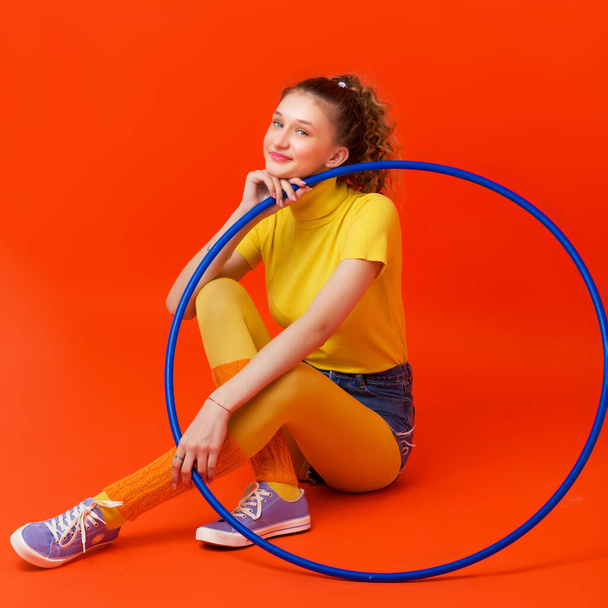 Happy fitness girl doing exercises with hula hoop - Foto, immagini
