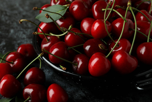 Sweet red cherry berries on dark background - Foto, afbeelding