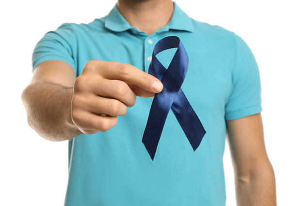 Man with blue ribbon on white background, closeup. Urology cancer awareness - 写真・画像