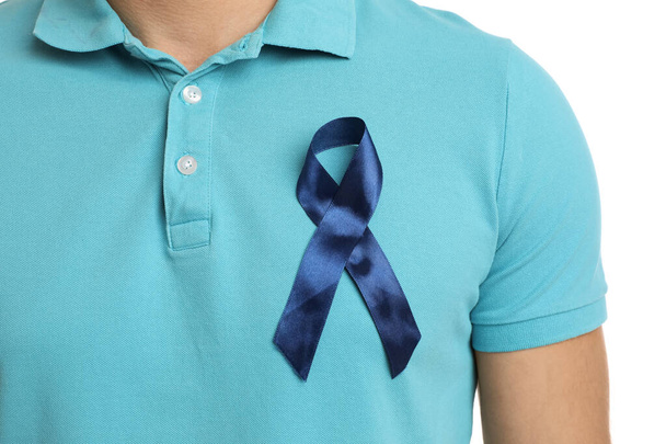 Man with blue ribbon on white background, closeup. Urology cancer awareness - Фото, изображение