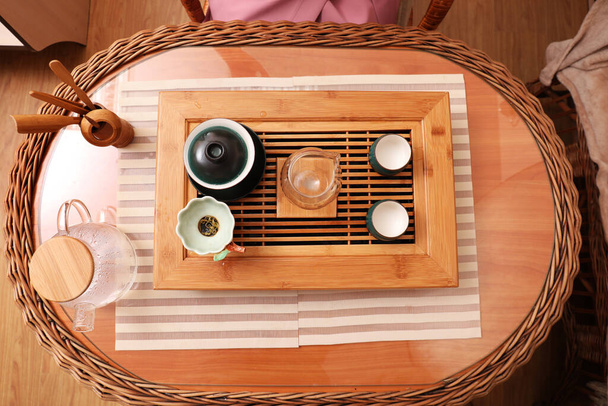 Beautiful set for traditional tea ceremony on wooden table indoors, flat lay - Photo, image