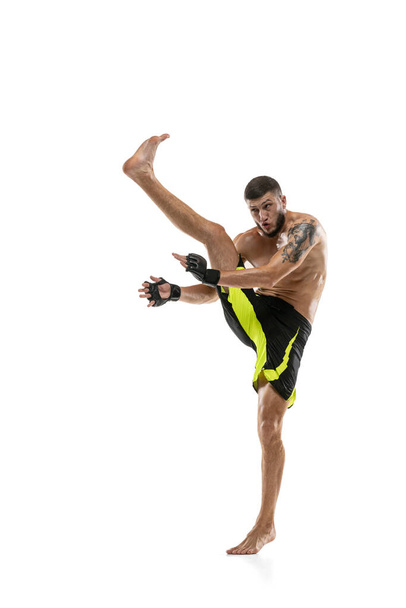 Professional male MMA boxer in motion isolated on white studio background. Fit muscular caucasian athlete fighting. - Foto, Bild