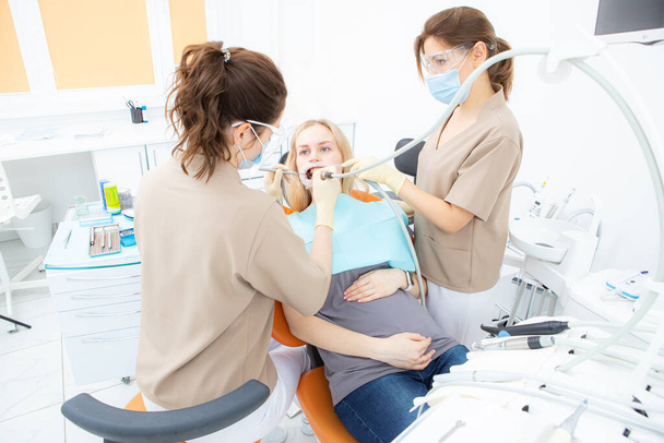 pregnant woman at the dentists office, checkup and dental treatment for pregnant women. - Fotografie, Obrázek