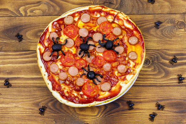 Halloween pizza with spiders on wooden table. Top view - Photo, Image