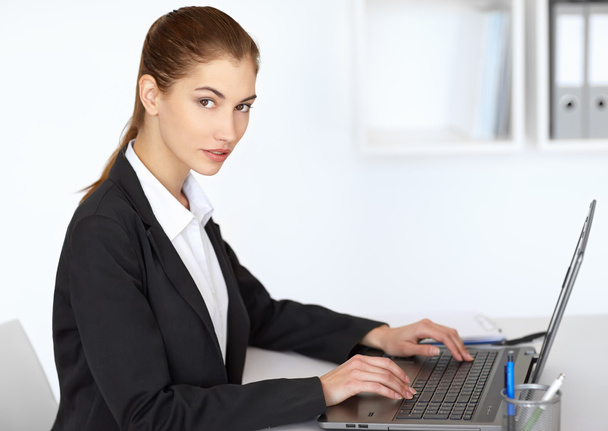 Businesswoman working at laptop - Photo, Image