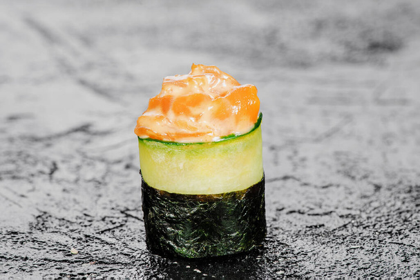 Gunkan sushi with salmon sashimi isolated on black background. Mockup. Photo for the menu and site - Photo, Image