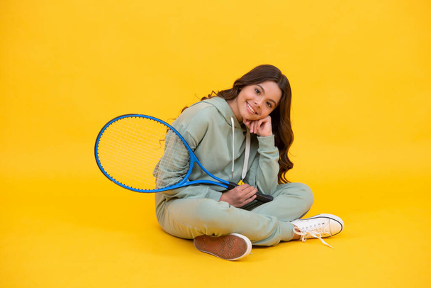 happy childhood. kid in sportswear hold racket. child with racquet. teen girl relax after sport - Photo, Image