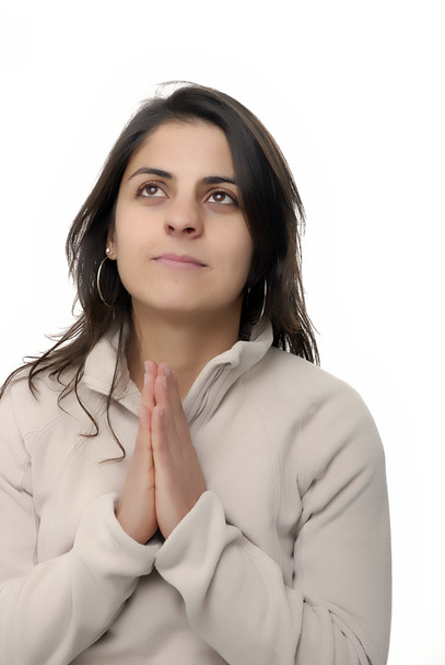 νεαρό κορίτσι προσεύχεται σε λευκό φόντο - Φωτογραφία, εικόνα