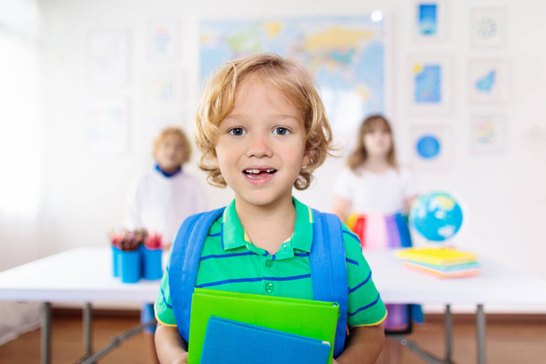 Kids in school. Preschool children in class. Happy kids back to school. Student in classroom. Child learning to read and write. Fun learning. Education for young kids. Little boy and girl study. - Photo, Image