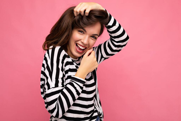 Photo shot of cute attractive pretty positive happy young brunette woman wearing casual striped longsleeve isolated over colorful background with copy space - Photo, Image