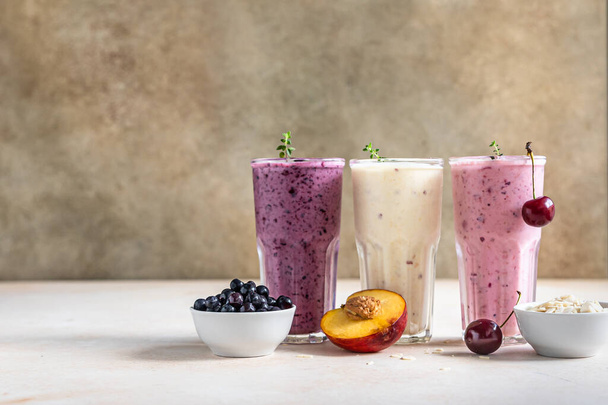 Colorful various smoothie or milkshake with assorted ingredients served in glasses with straw. Healthy food concept. Selective focus. - 写真・画像