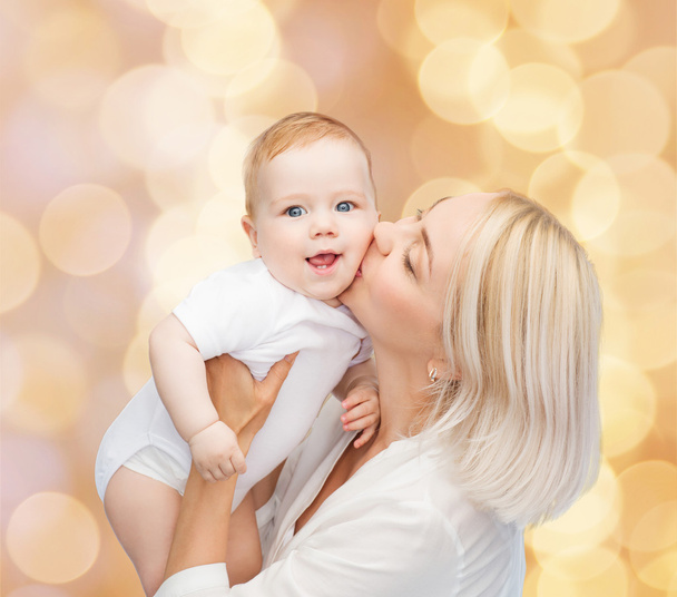 happy mother kissing smiling baby - 写真・画像