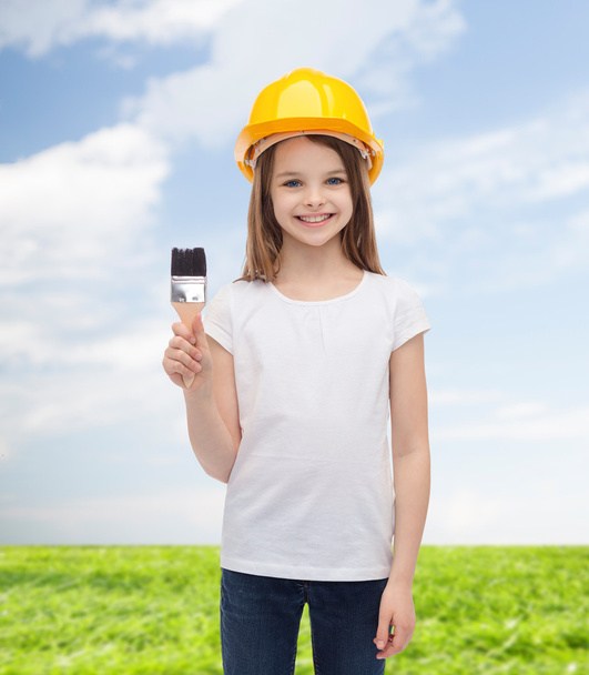 smiling little girl in helmet with paint roller - Photo, Image