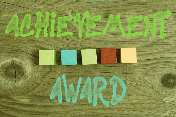 Conceptual caption Achievement Award. Conceptual photo recognizes worthy and outstanding achievement in job skill Stack of Sample Cube Rectangular Boxes On Surface Polished With Multi-Colour - Zdjęcie, obraz