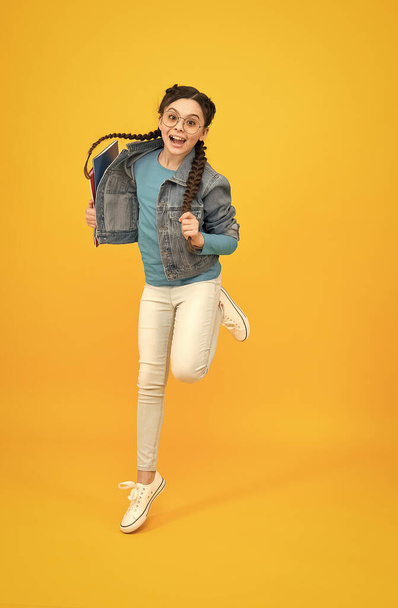 back to school. vision concept. sense of freedom. jumping teenage girl in eyeglasses. kid with braided hair. happy after optometrist. beauty and fashion. eyesight correction of child. happy childhood - Photo, Image