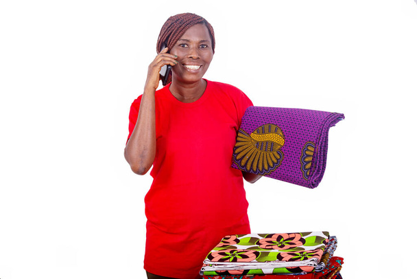 портрет красивої усміхненої жінки, що розмовляє на мобільному телефоні, тримаючи традиційну пов'язку
. - Фото, зображення