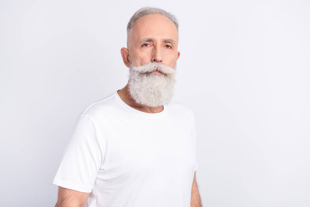 Photo of serious calm grandfather wear white t-shirt peaceful mood bearded man isolated on grey color background - Zdjęcie, obraz