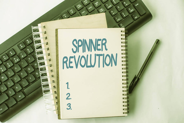 Text caption presenting Spinner Revolution. Internet Concept a toy that help relieve stress and cope with anxiety Two Plain Lined Spiral Notebooks With Pen And Keyboard On Table. - Valokuva, kuva