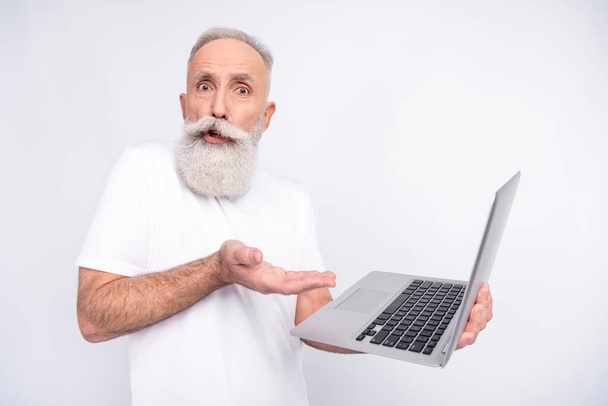 Photo of stressed unhappy old grandfather clueless technology hold laptop isolated on grey color background - Zdjęcie, obraz
