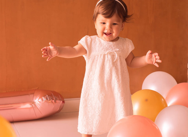 Little one year girl baby with balones and dolly  - Photo, image
