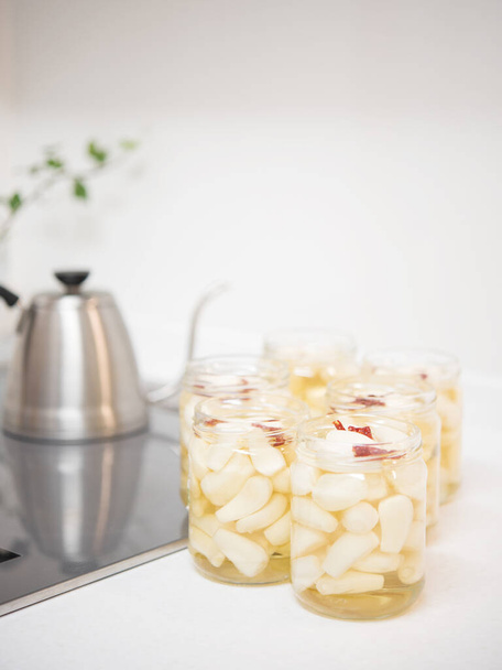 Japanese pickled shallots in jar on mable countertop. Japanese food - Photo, Image