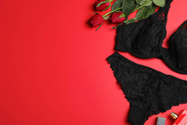 Flat lay composition with sexy lingerie on red background. Space for text - Фото, зображення