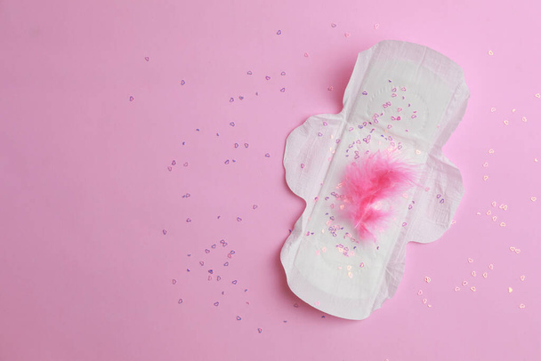 Menstrual pad and confetti on pink background, top view. Space for text - Фото, зображення