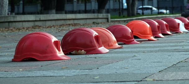Kiev, Ukraine September 26, 2020: Workers' helmets lined up in a square in protest - Photo, Image