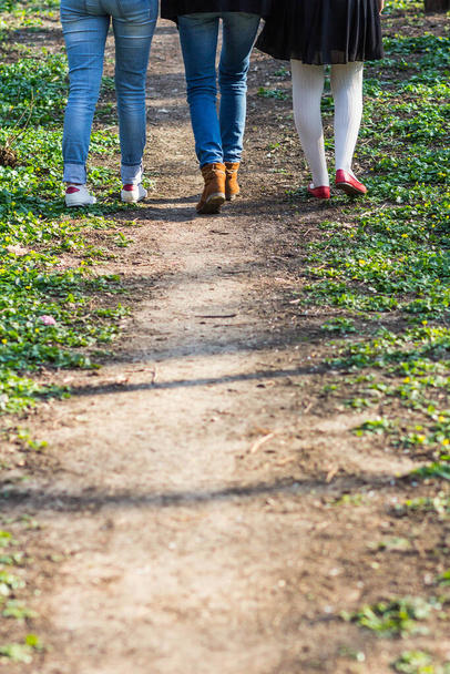 Back torso of three women walking on a path  - Foto, Imagen