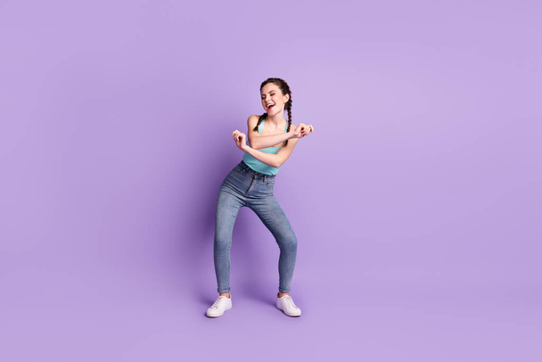 Full length body size view of pretty cheerful carefree girl dancing moving having fun isolated over violet purple color background - Foto, Bild