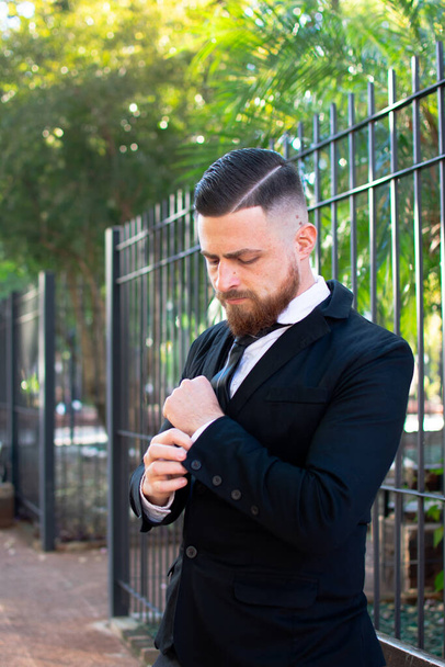 An attractive Hispanic male in an elegant suit posing at camera - Valokuva, kuva