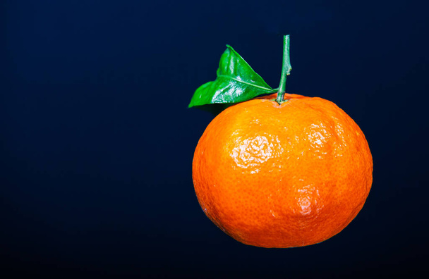 A fresh orange fruit isolated on a blue background - Fotografie, Obrázek