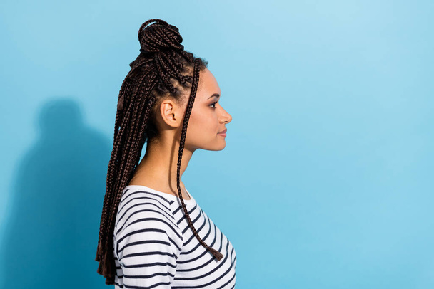Side profile photo portrait of girl with dreadlocks looking copyspace serious isolated pastel blue color background - Foto, afbeelding