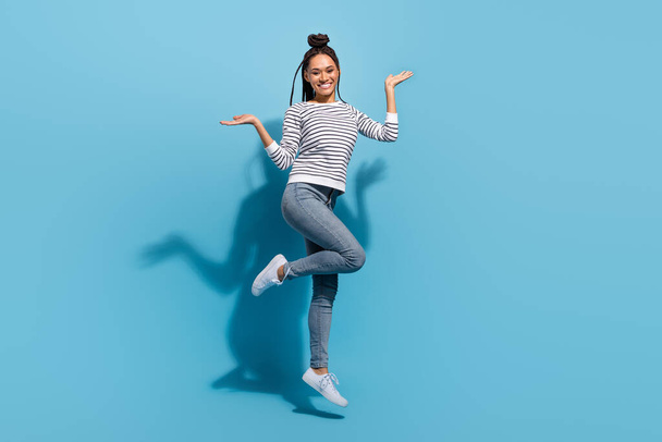 Full body profile side photo of young cheerful african girl happy positive smile jump isolated over blue color background - Φωτογραφία, εικόνα