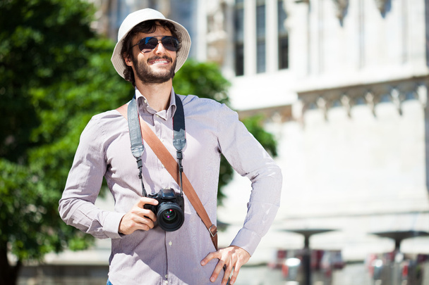 Tourist holding a digital camera - 写真・画像