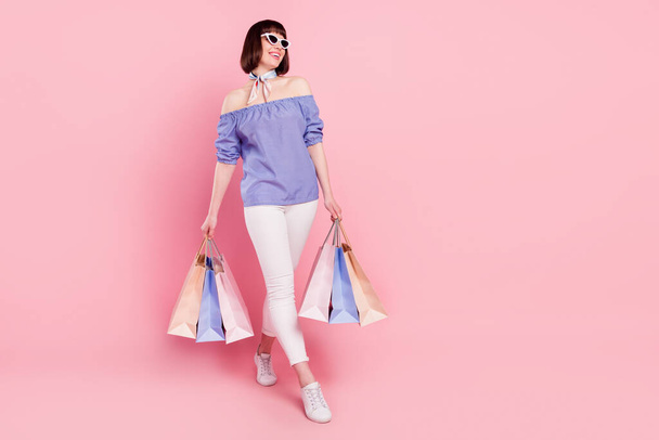Full length body size photo woman keeping bargains shopping in mall laughing in sunglass isolated on pastel pink color background - Φωτογραφία, εικόνα