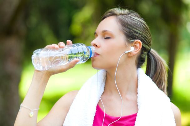 Woman refreshing after running - Photo, Image